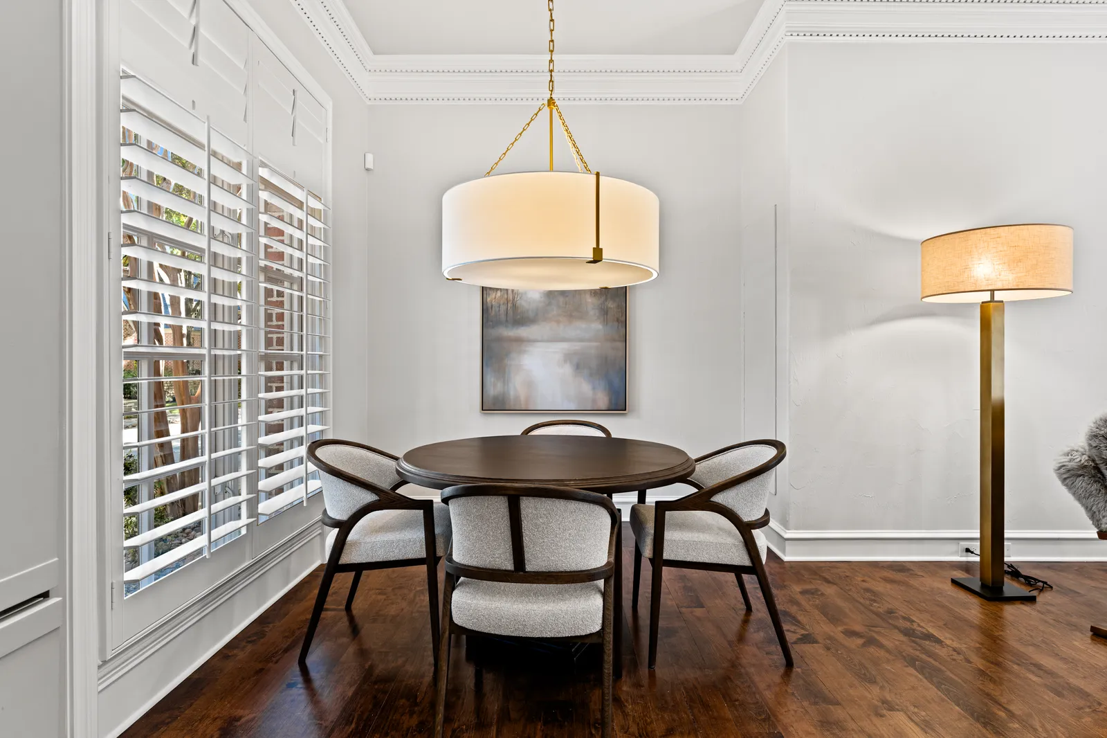 Breakfast nook at Prestwick Ln in Dallas after fresh paint, a new pendant, and refinished hardwood floors
