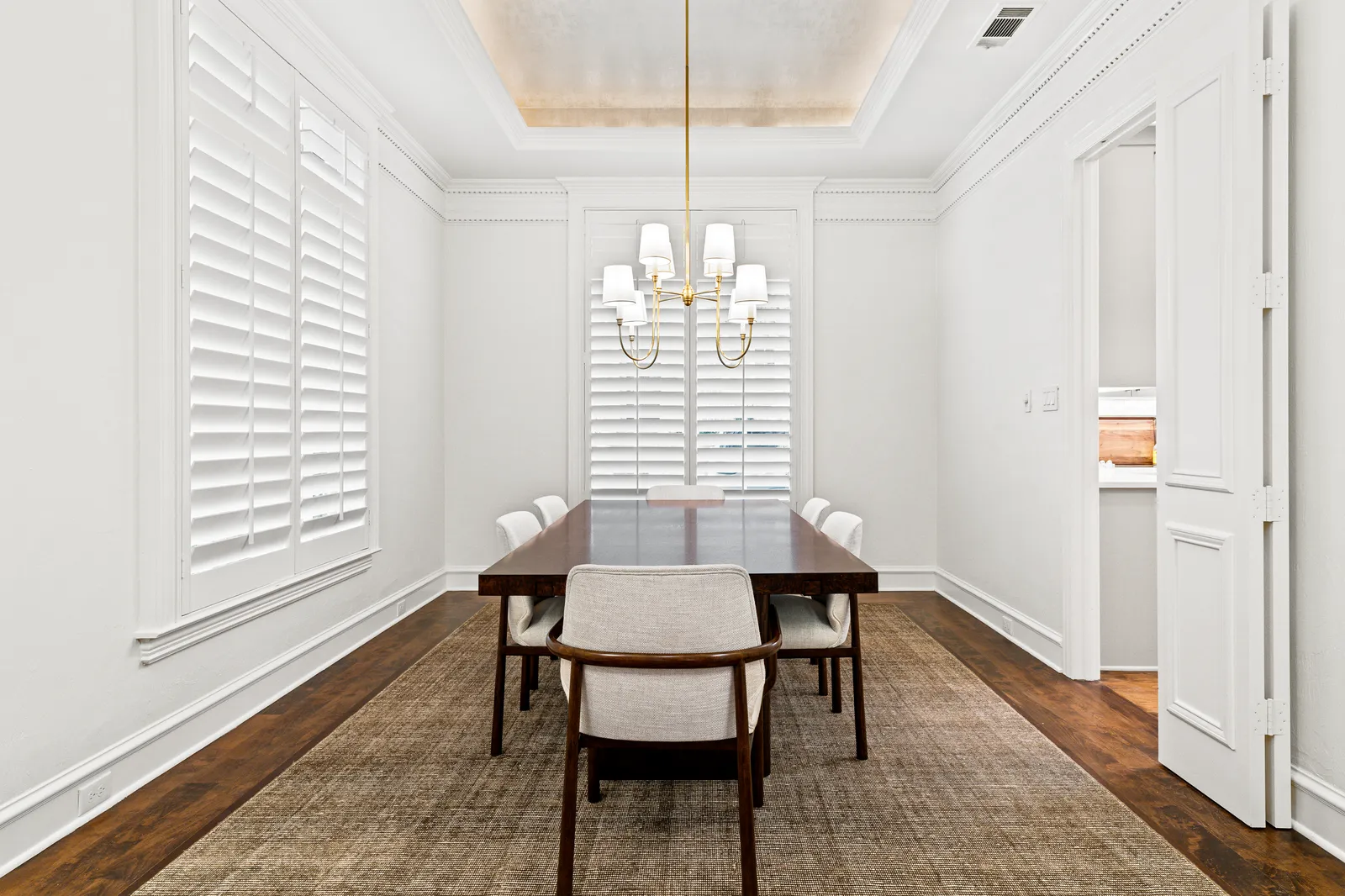 Dining room at Prestwick Ln in Dallas after fresh paint, new lighting, and refinished floors
