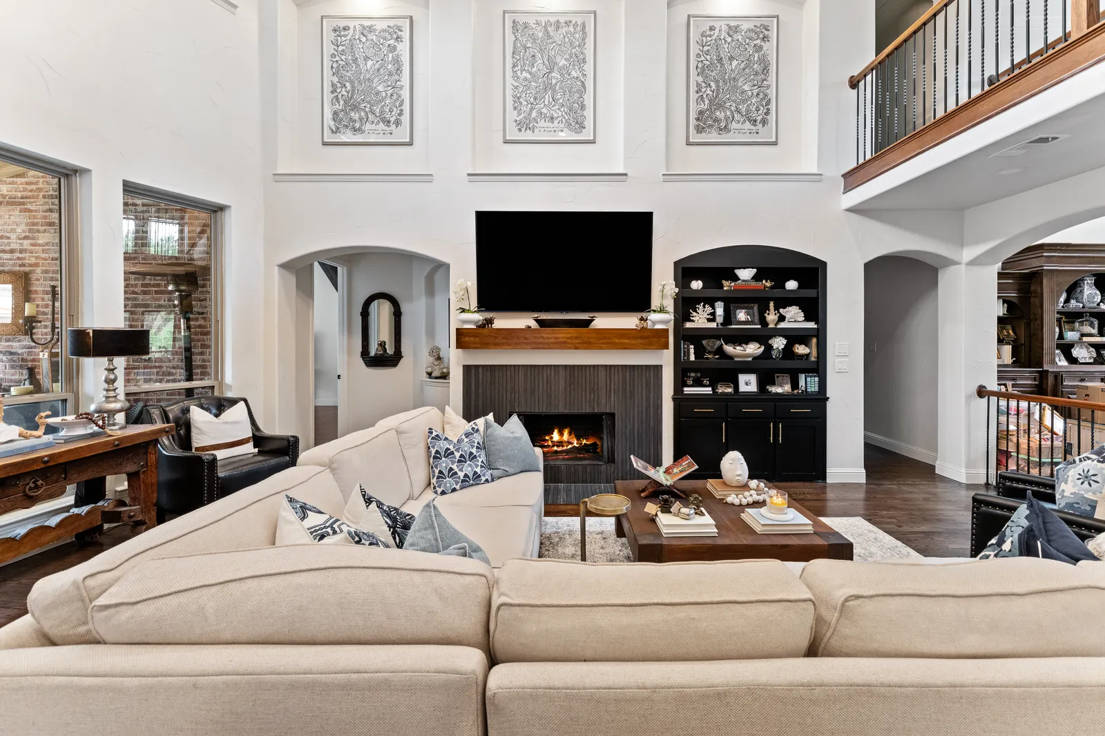 Living room at Shady Point Dr in Plano after a whole-home remodel: new fireplace, built-ins, and updated lighting