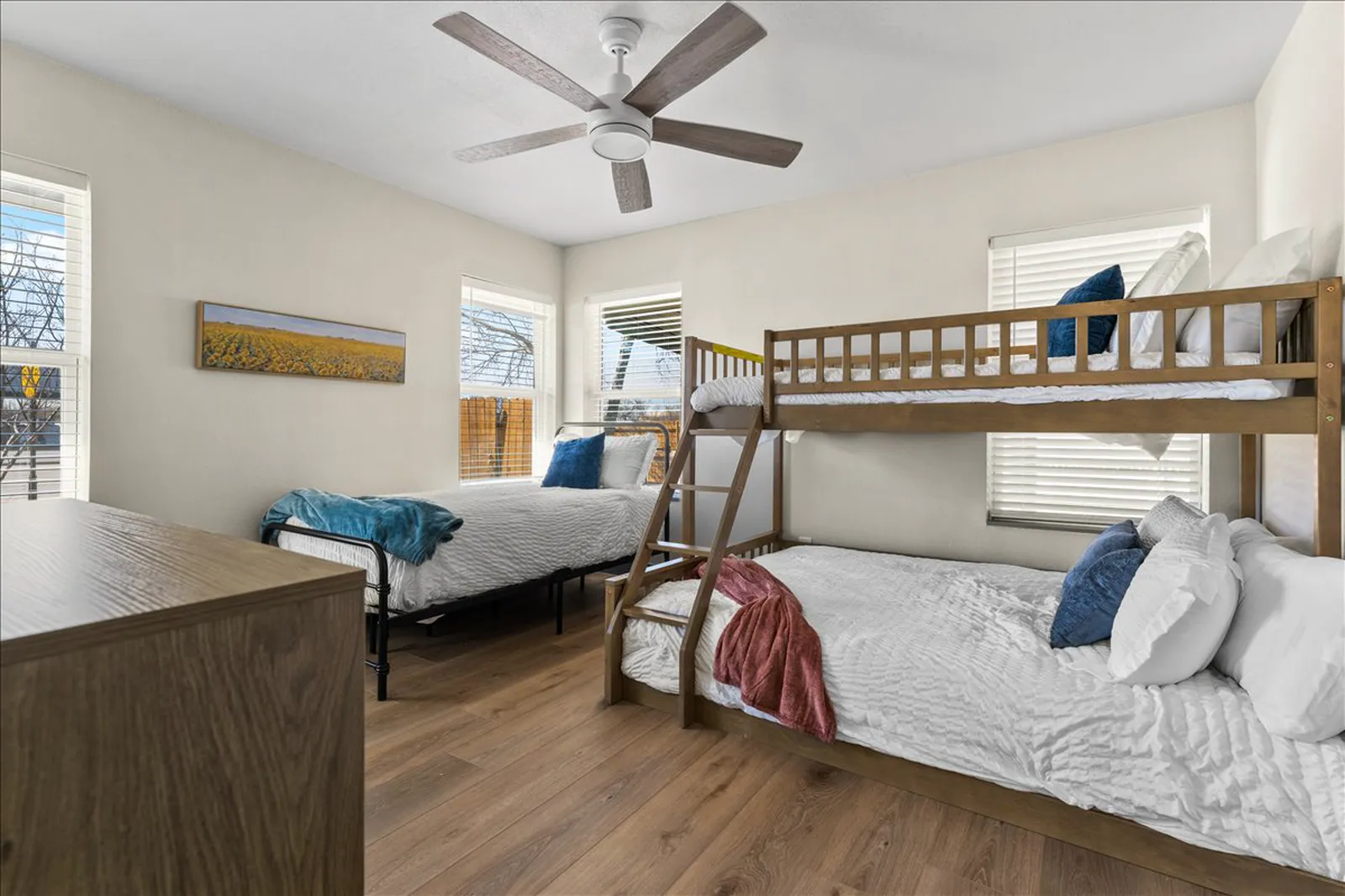 Bunk room with new flooring, paint, and lighting at Sherman St. in Melissa