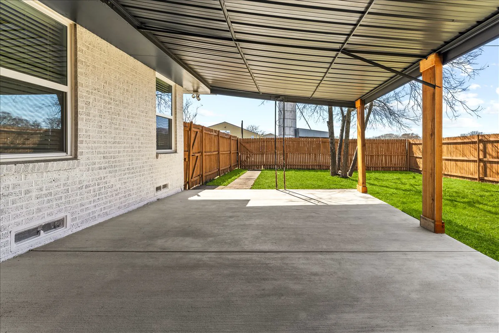 Covered back patio and new lawn at Sherman St. in Melissa